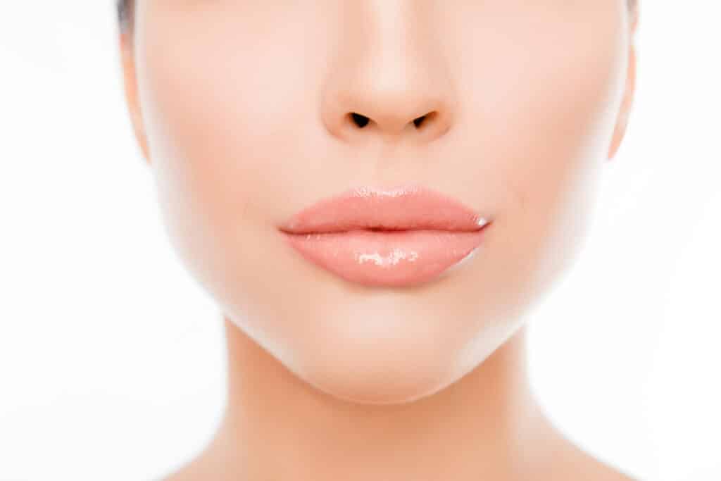 Close up photo of woman's face with perfect skin and lips