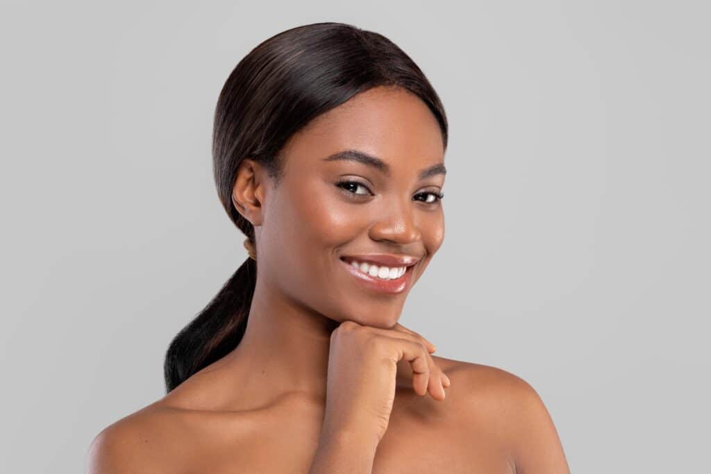 A woman smiling and showing the results of Co2 fractional resurfacing in Fort Worth, TX