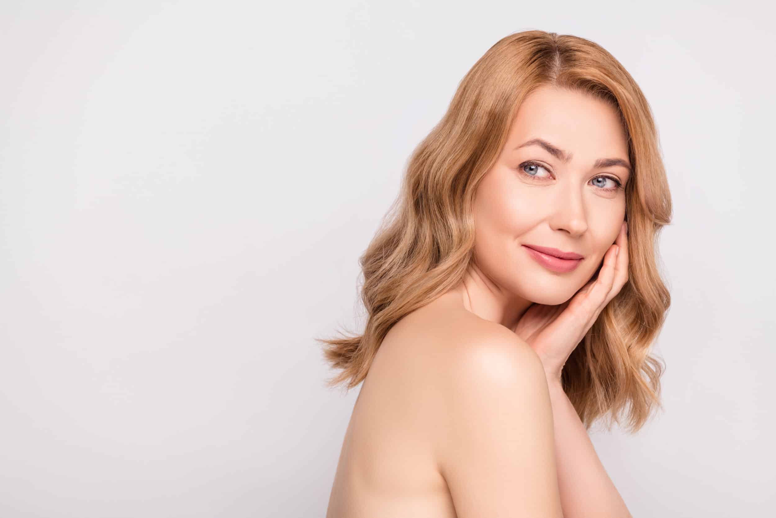 A woman looking over her shoulder showing the results of skin tightening in Fort Worth