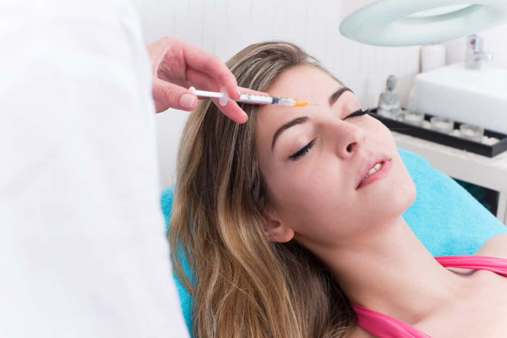 A woman getting BOTOX Cosmetic in her forehead