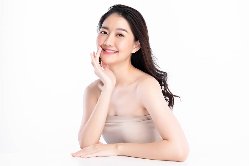 A woman smiling and showing the results of SmartSkin+™ CO₂ Fractional Resurfacing in Fort Worth